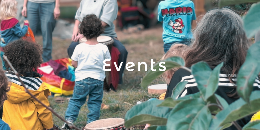 Children and Adults in a green space enjoying an event