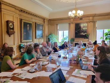 a group of people sat around a table discussing RHS Space to Grow report