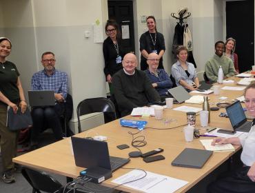 a group of people having a meeting smile for the camera
