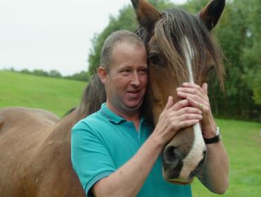 Man with a horse on a care farm