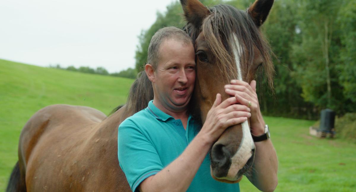 Man with a horse on a care farm