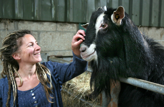 Dr Rachel Bragg on a care farm with a goat